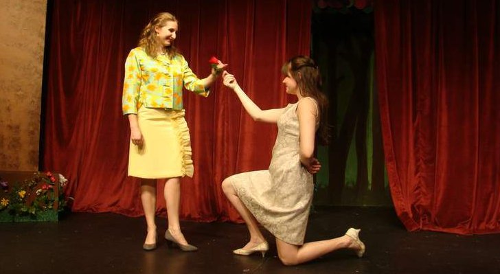 Rosalind (Julianne McGourty) offers a rose to her cousin Celia (Sonya Richards) in Stageloft's production of "As You Like It."